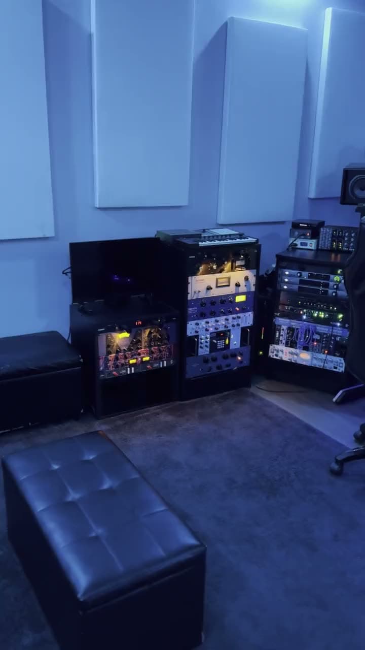 A slow pan across the control room racks and desk